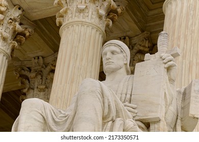 Washington, DC, USA - April 3, 2022: The Entrance To The Historic U.S. Supreme Court Building On Capitol Hill Is Flanked By Two Iconic Marble Figures Created By Renown Sculptor James Earl Fraser.