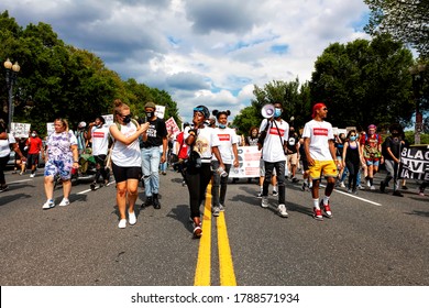 Washington, DC, USA - August 1, 2020: Protesters exercise their First Amendment rights walking down Constitution Avenue past the White House at the Demand DC march, hosted by The Palm Collective