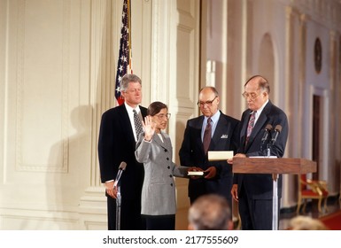 Washington DC, USA -AUGUST 10, 1993 
Ruth Bader Ginsburg Is Sworn In As Associate Justice Of The Supreme Court Of The United States. President Clinton Stands Behind Her With Her Husband Martin 