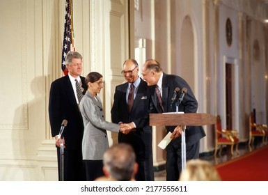 Washington DC, USA -AUGUST 10, 1993 
Ruth Bader Ginsburg Is Sworn In As Associate Justice Of The Supreme Court Of The United States. President Clinton Stands Behind Her With Her Husband Martin 