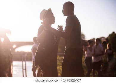 Washington, D.C. / USA - August 12, 2019: Latin Dancers Gather Outside Along The Georgetown Waterfront And Practice Their Bachata, Salsa, Zouk And Kizomba Dancing In A Public Park With A Speaker.