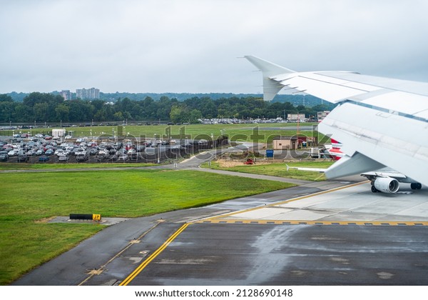 Washington DC, USA -\
August 17, 2021: Airplane view through window of plane landing on\
Washington DC Reagan National Airport District of Columbia runway\
in Northern Virginia