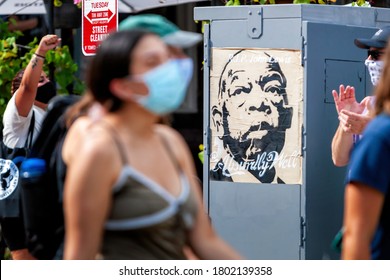 Washington, DC, USA - August 22, 2020.  Protesters Walk Past A Portrait Of John Lewis During The Defund The Police March In Columbia Heights, Sponsored By DC Protests