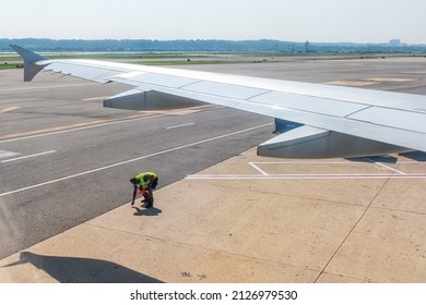 Washington DC, USA - August 25, 2021: Airplane View Through Window Of Plane In Washington DC Reagan Airport Runway Gate In Virginia With Worker Checking Safety Of Road