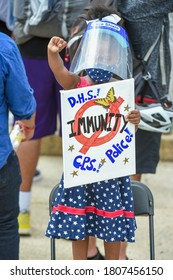 Washington, DC, USA - August 28, 2020: A Young Child Is Seen Wearing A Covid-19 Shield And Holding Up A Sign During The Commitment March On Washington For Racial Equality And Justice. 