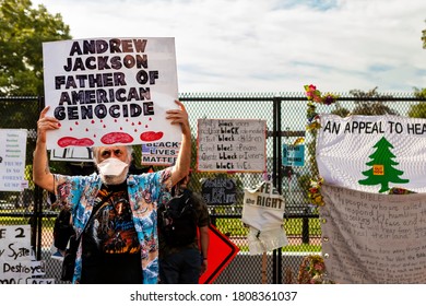 Washington, DC, USA - August 28, 2020: A Man Stands At Lafayette Square And Its Statue Of Andrew Jackson With A Sign That Says Jackson Is The 