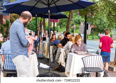 Washington DC, USA - August 4, 2017: People Sitting At Outside Area Patio Tables On M Street In Georgetown Das Ethiopian Cuisine Restaurant In Evening