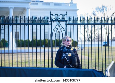 Washington, DC / USA - Circa February 2018: A Female Secret Service Agent Seen At The Outer Boundary Of The White House Armed With Rifle