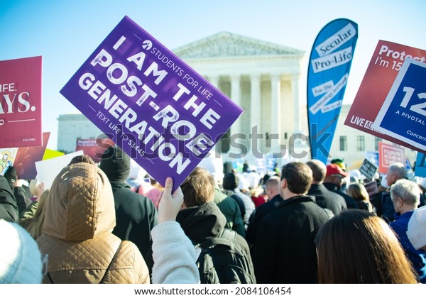 WASHINGTON,\
DC, USA – DECEMBER 1, 2021:  Protesters rally outside the Supreme\
Court as the court revisits Roe v. Wade and the issue of abortion\
rights in Washington, DC on December 1,\
2021