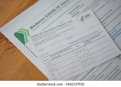 Washington, DC, USA - December, 23, 2020: Blurred COVID-19 Vaccination Record Card By CDC On Moderna Vaccine Preparation Form. Vaccine Passport For Travel Concept. 