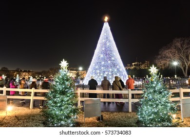 Washington DC, USA - December 29, 2016: National Mall Christmas Tree With Visitors During Sunset Illuminated