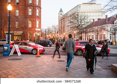 Washington DC, USA - December 29, 2016: People crossing street on Pennsylvania avenue in downtown at dusk by national mall