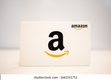 Washington, D.C. / USA - Feb. 26, 2020: An Amazon.com gift card is against a plain white background. The card can be used to make purchases on the Amazon website, a company founded by Jeff Bezos.