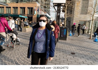 Washington D.C., USA - February 26, 2022: A Young Woman Wearing Purple Beads And A Mask Is At Mardi Gras Celebration At The District Wharf