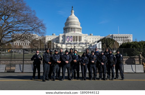 Washington, DC, USA - Jan. 10, 2020: Police officers\
line the streets to watch the procession for the body of Capitol\
Police Officer Brian Sicknick, who died during the Capitol Riots on\
January 6.
