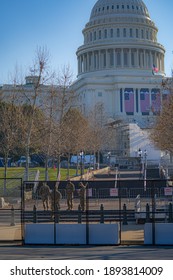 Washington, DC, USA - January, 12, 2021: Members Of The National Guard Stand Inside An Anti-scaling Fencing That Surrounds The US Capitol Building Supporting Capitol Security. 