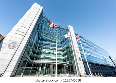 Washington DC, USA - January 13, 2018: US United States Securities and Exchange Commission SEC entrance architecture modern building sign, entrance, american flag, looking up sky, glass windows 