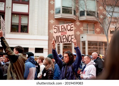 Washington, DC USA - January 20th, 2017: Man holding a silence equals violence sign at a protest during the Trump Presidential Inauguration.