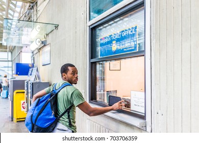 Washington DC, USA - July 1, 2017: Inside Union Station in capital city with young man at bus ticket booth