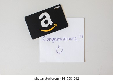 Washington, D.C. / USA - July 10, 2019: A $50 Amazon gift card allows the recipient to purchase items from the Amazon.com website. A note congratulates the recipient for winning the gift certificate.