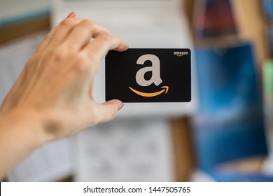 Washington, D.C. / USA - July 10, 2019: A hand holds a $50 Amazon gift card, a which allows the recipient to purchase items from the Amazon.com website.
