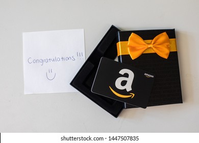 Washington, D.C. / USA - July 10, 2019: A $50 Amazon gift card allows the recipient to purchase items from the Amazon.com website. A handwritten note congratulates the winner of the gift certificate.