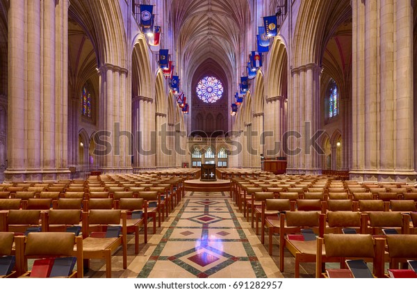 Washington DC, USA - July 22nd 2017 - Interior\
view of the main aisle in the Cathedral Church of Saint Peter and\
Saint Paul in Washington DC commonly referred to as Washington\
National Cathedral.