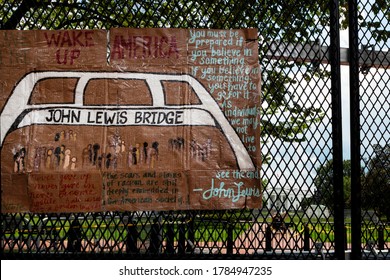 Washington, DC, USA - July 25, 2020: Protest Art In Tribute To Congressman John Lewis, Hero Of The Civil Rights Movement, Hangs On The Fence At Lafayette Square With The White House In The Background