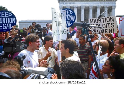 Washington DC, USA, July 3, 1989 
Pro-life and pro-choice demonstrators hold signs on the steps of the Supreme Court building  The protests came after the court ruled on Webster v. Reproductive rights