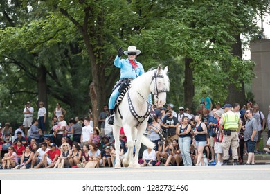Washington, D.C., USA - July 4, 2018, The National Independence Day Parade, Man dress up as the Lone Ranger, riding a horse down constitution avenue