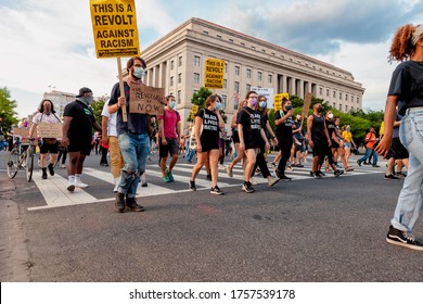 Washington, DC, USA - June 15, 2020: People march through the National Mall protesting police brutality and the murders of African-Americans in support of Black Lives Matter