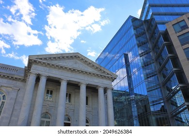 Washington, DC, USA - March 14 2021: Greek architecture building with modern glass building.