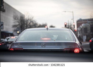 Washington, DC / USA - March 3, 2019: An acura car model is stopped at a red light in the Friendship Heights / Chevy Chase neighborhood on an overcast afternoon.