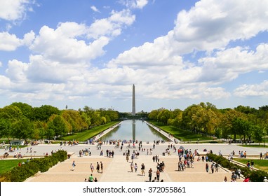 WASHINGTON DC, USA - MAY 2, 2015: The Washington Monument seen from the Lincoln Memorial with the Reflecting Pool in front and many visitors.