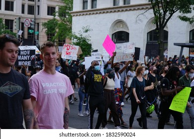 Washington, DC - USA - May 31, 2020. Black Lives Matter (BLM) Protest In Front Of The White House (Lafayette Square). Gay Couple (foreground) And People In The Crowd Show Protest Signs.