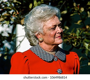 Washington, DC., USA, November 30, 1989Barbara Bush listens to her husbnd Preident George H.W. Bush speak during ceremony in  the Rose Garden of the White House.