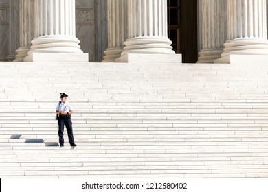 Washington DC, USA - October 12, 2018: Police Security Officer Guard Woman Standing On Steps Of Supreme Court Building Marble Stairs Closeup On Capital Capitol Hill, Columns, Pillars