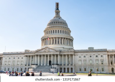 Washington DC, USA - October 12, 2018: US Congress dome construction facade exterior on Capital capitol hill with blue sky, columns pillars and people tourists