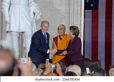 Washington DC, USA, October 17, 2007  
Speaker Nancy Pelosi Shakes Hands  With The 14th Dalia Lama Lhamo Dondrub Of Tibet In The Rotunda Of The US Capital As President George W. Bush Looks On 