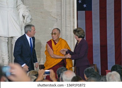 Washington DC, USA, October 17, 2007  
Speaker Nancy Pelosi Shakes Hands With The 14th Dalia Lama Lhamo Dondrub Of Tibet In The Rotunda Of The US Capital As President George W. Bush Looks On From Left