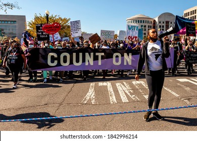 Washington, DC, USA - October 17, 2020: A Leader In The DC Racial Justice Movement Leads The Crowd In Chants In Front Of The Women's March Banner That Says 