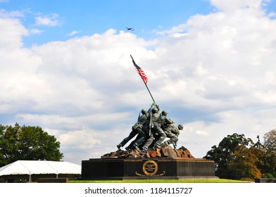 WASHINGTON DC, USA - OCTOBER 25, 2016 : Iwo Jima Memorial In Washington DC At Sunny Day With Plane In The Sky. The Memorial Honors The Marines Who Have Died Defending The US Since 1775.