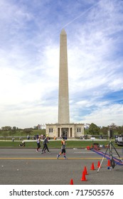 Washington D.C, USA, october 30, 2016: Runners compete in the Marine Corps Marathon under the George Washington Monument in Washington, D.C