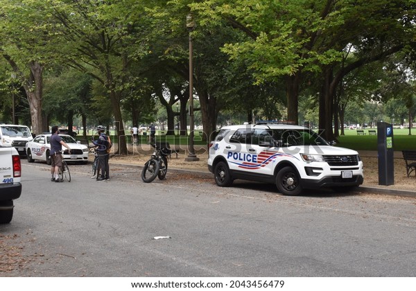 Washington, DC, USA - September 18, 2021: Police\
cars and police officers on bicycles along Jefferson Drive near the\
Justice for J6\
Protest
