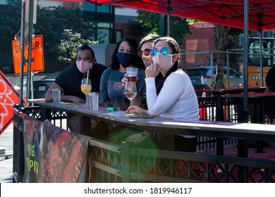 Washington, DC, USA - September 19, 2020: Bar Patrons Watch Protesters Participating In The March For Justice Proceed Down 14th Street Through The Entertainment District Of A Gentrified Area