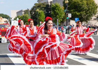 Washington DC, USA - September 21, 2019: The Fiesta DC, Colombian women wearing traditional clothing, performing Cumbia dance during the parade