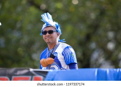 Washington, D.C., USA - September 29, 2018: The Fiesta DC Parade, Man From El Salvador Wearing A Colorful Wig With The Colors Of The Salvador National Flag