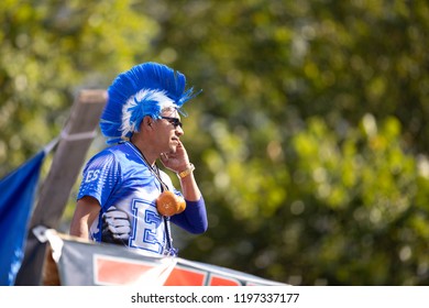 Washington, D.C., USA - September 29, 2018: The Fiesta DC Parade, Man From El Salvador Wearing A Colorful Wig With The Colors Of The Salvador National Flag