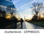 Washington DC - A Veteran looks for a name at Vietnam Veterans Memorial Wall  at sunrise