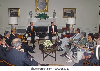 Washington, DC.USA, 1989
President George H.W. Bush Flanked By Secretary Of State James Baker III On The Left Holds A Meeting With His Cabinet Members In The Oval Office Of The White House.
